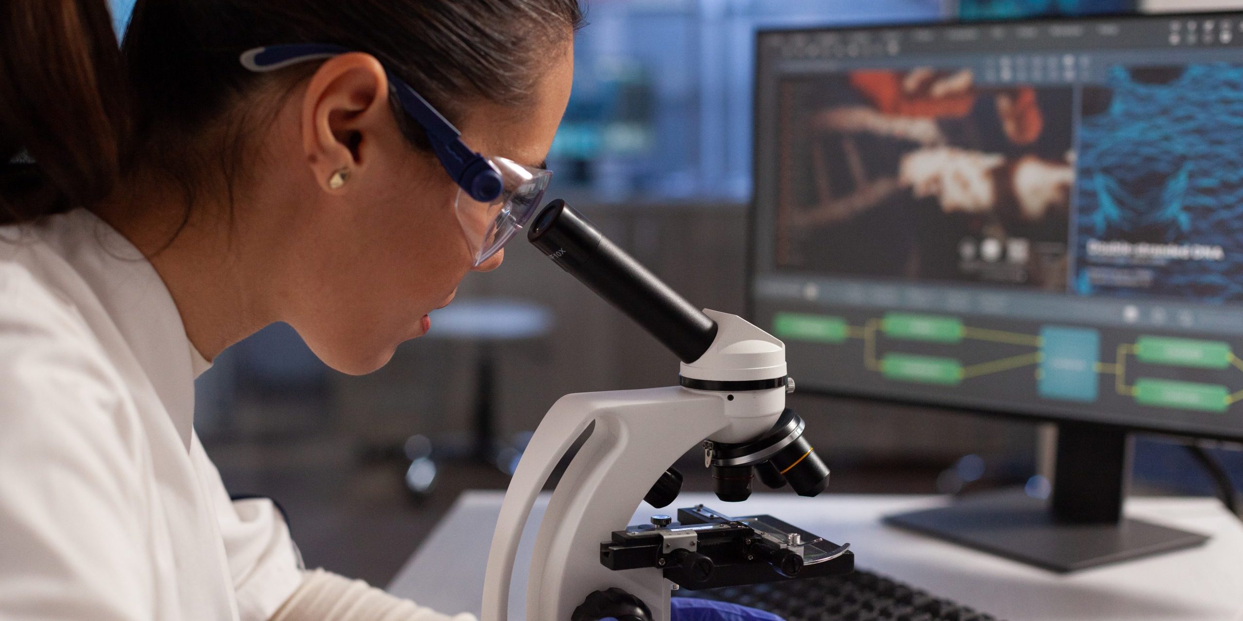 Biochemist working on microscope for cell illustration